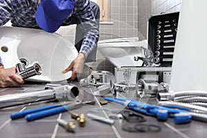 Plumber at work in a bathroom, plumbing repair service, assemble