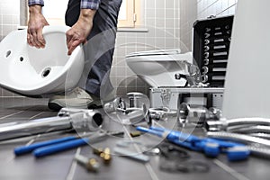 Plumber at work in a bathroom, plumbing repair service, assemble