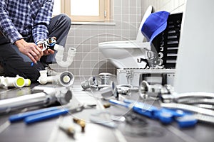 Plumber at work in a bathroom, plumbing repair service, assemble