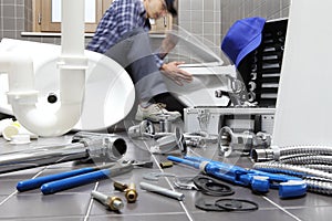 Plumber at work in a bathroom, plumbing repair service, assemble