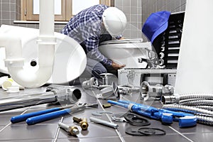 Plumber at work in a bathroom, plumbing repair service, assemble photo