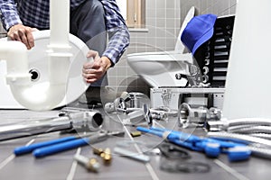 Plumber at work in a bathroom, plumbing repair service, assemble