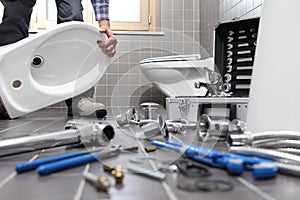 Plumber at work in a bathroom, plumbing repair service, assemble photo