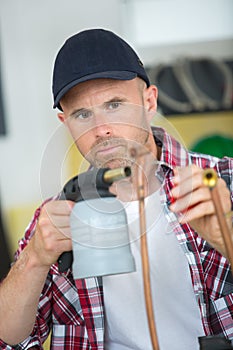 Plumber at work with blowtorch