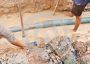 Plumber work dig repair water line connect.PVC pipe main plumbing on road and backhoe