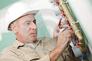 Plumber at work installing water meter