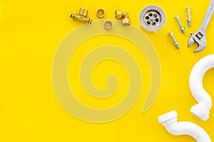 Plumber work with instruments, tools and gear on yellow background top view mockup