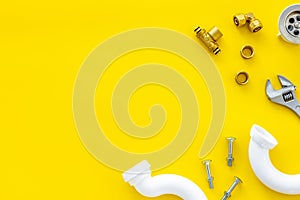 Plumber work with instruments, tools and gear on yellow background top view mockup