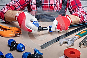 Plumber at work in a kitchen, plumbing repair service