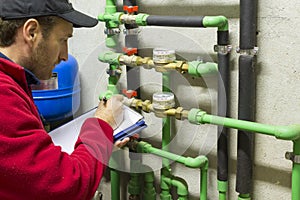 Plumber at work making the consumption metering