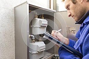 Plumber at work making the consumption metering photo