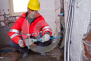 Plumber at work in a site