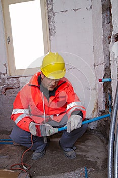 Plumber at work in a site