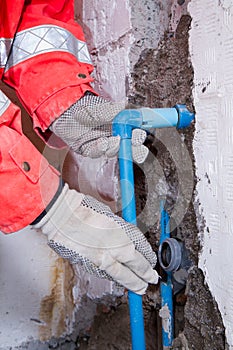 Plumber at work in a site