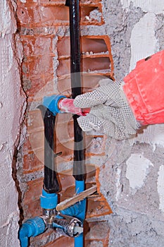 Plumber at work in a site