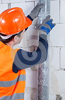 Plumber working at construction site