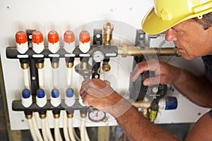 Plumber Working On Pipework