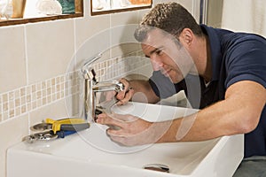 Plumber working on sink