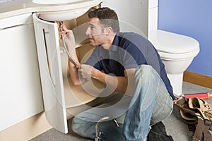 Plumber working on sink