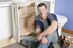 Plumber working on sink