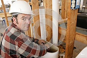 Plumber Working in Toilet Tank