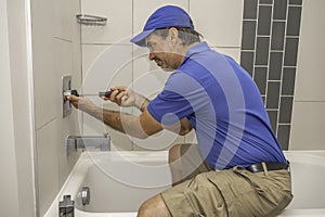 Plumber working on tub cartridge