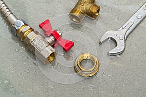 Plumbing faucet and a wrench in water drops during equipment repair during an accident