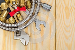 Plumbing materials, faucet, tools, fittings and hose on wooden boards are used to replace or repair