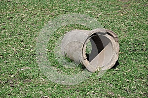 Plumbing pipe made of concrete on the lawn.