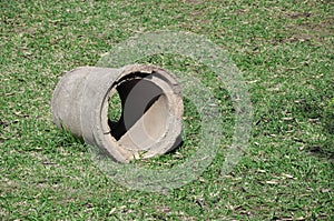 Plumbing pipe made of concrete on the lawn.