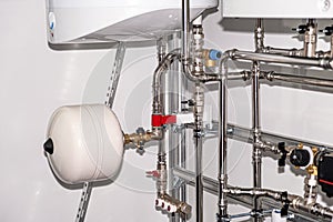 Plumbing services. Stainless steel piping of the heating system in the boiler room. Heating thermoregulation system