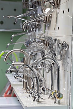 Plumbing store interior, stand of water taps