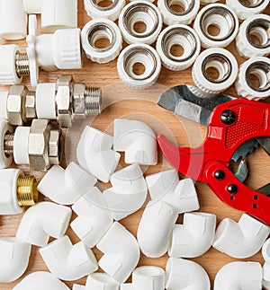 Plumbing tool pipes and fittings on white background