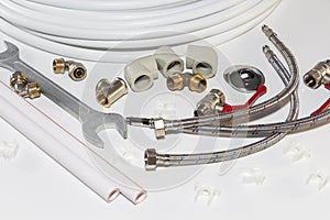Plumbing tools and equipment on white with copy space