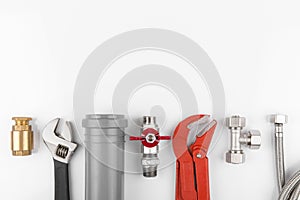 Plumbing tools and equipment on white with copy space