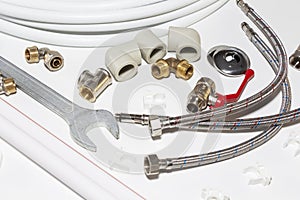 Plumbing tools and equipment on white with copy space