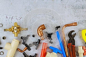 Plumbing tools, pipe fittings on a home improvement plumbing materials including copper pipe, elbow joint, wrench and spanner
