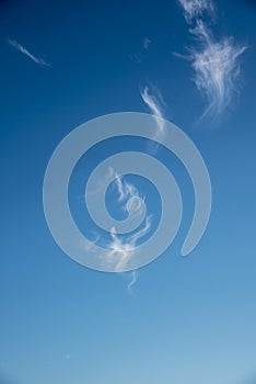 Plumes of clouds over blue sky