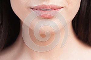 Plump sensual lips of young beautiful woman close up