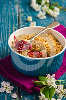 Plums crumble pie on blue ramekin