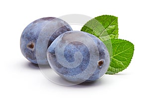 plums with leaves isolated on white background.