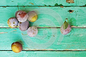 Plums on old turquose color surface photo