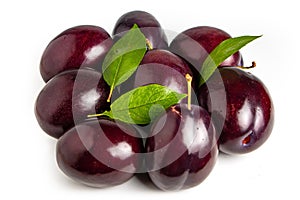 Plums with plum leaves on a white background