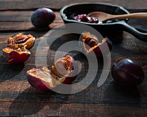 Plums and jam on dark table