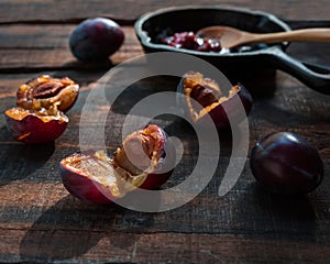 Plums and jam on dark table photo