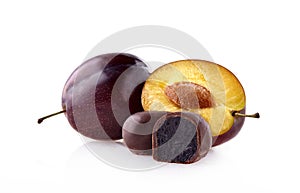 Plums with prunes in chocolate on white background.