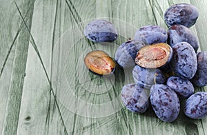 Plums `prunes` on a natural background in the morning rays