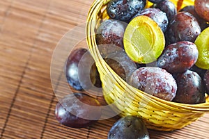 Plums in weaved basket