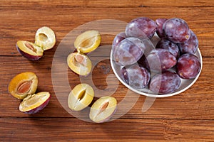 Plums on wood, halfed
