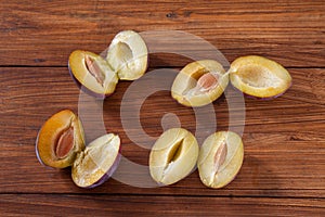 Plums on wood, halfed